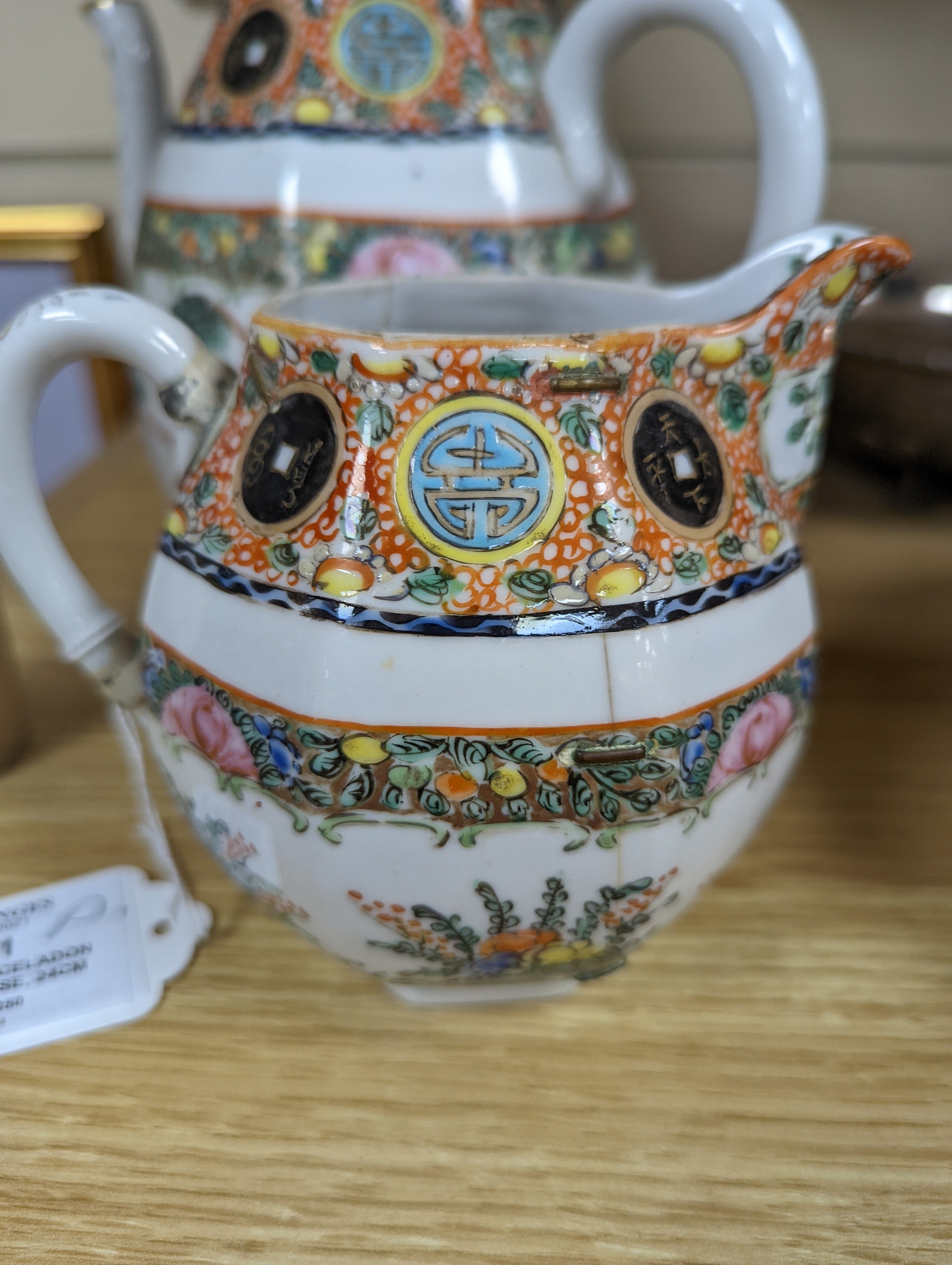 A Chinese celadon glazed vase, 24cm and a Chinese famille rose teapot and matching cream jug, a.f.
